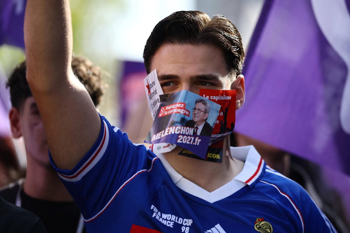 A supporter of Jean-Luc Melenchon, leader of French far-left opposition party La France Insoumise (France Unbowed - LFI) and candidate for the 2027 French presidential election, wears stickers on his face during a demonstration by French high school and university students in Paris as part of a nationwide protest movement led by students, supported by teachers, school parents and labour unions, demanding better school conditions and concrete measures, France, October 13, 2026. REUTERS/Sarah Meyssonnier