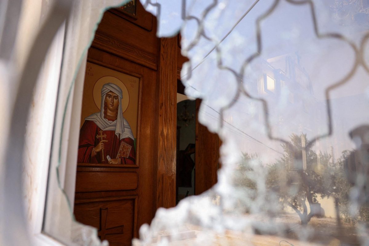 A shattered window at Saint George’s Greek Orthodox Church, where gunmen opened fire during a funeral the previous day, in the village of Hamoud, Karak, Jordan, October 24, 2026. REUTERS/Alaa Al Sukhni     TPX IMAGES OF THE DAY
