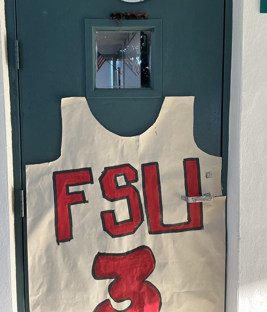 A door on the 600 building includes crafted FSU basketball jersey of Kam Taylor with fake hair, resembling his, above the window.