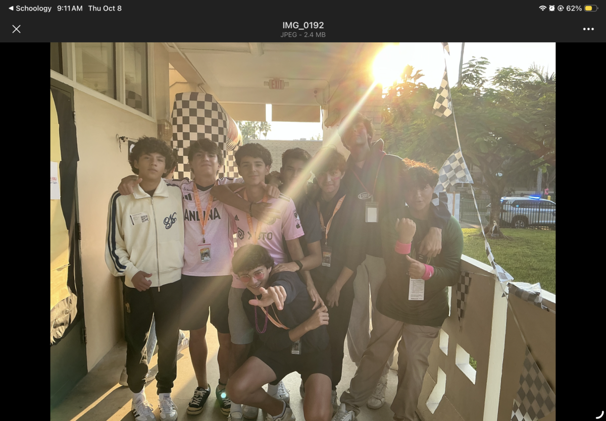 A group of boys wearing pink have a good time. 