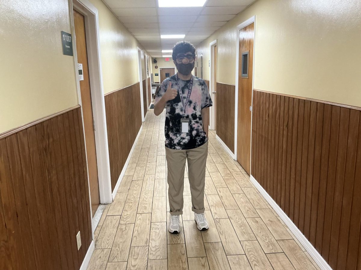 Freshman Fabian Shiera in his tacky spirit with a fake beard and a tie-dye shirt.