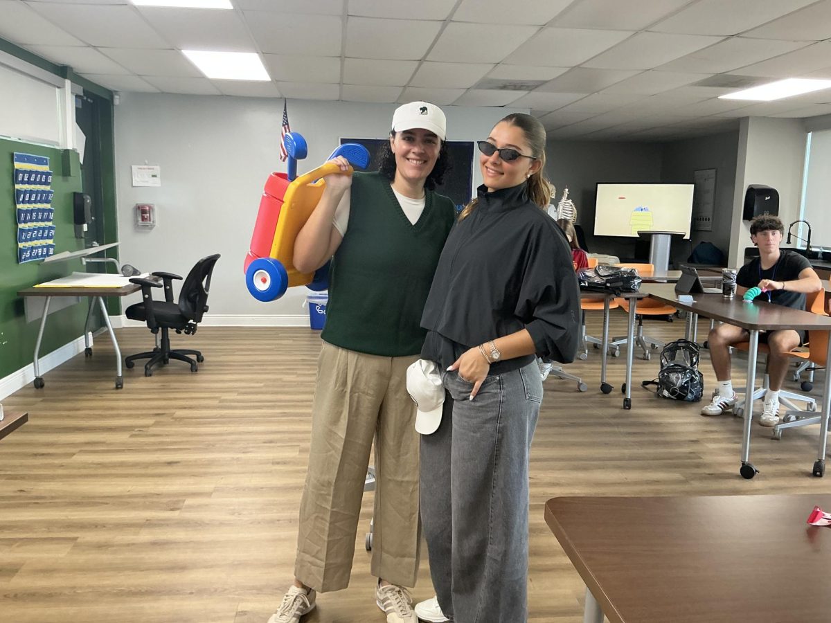 Teacher and student pose up together representing their class/faculty.