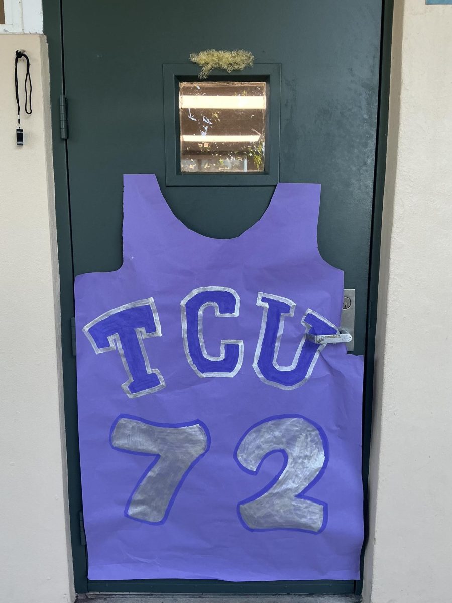 A door has basketball player Jackson Jones’s jersey with fake hair resembling his above the window in the 600 building.