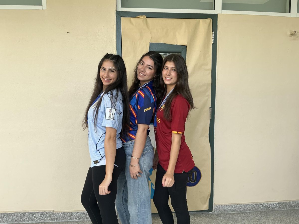 Juniors Chiara Nerguizian, Luciana Larrea, and Victoria Otero pose for a picture with World Cup jerseys.