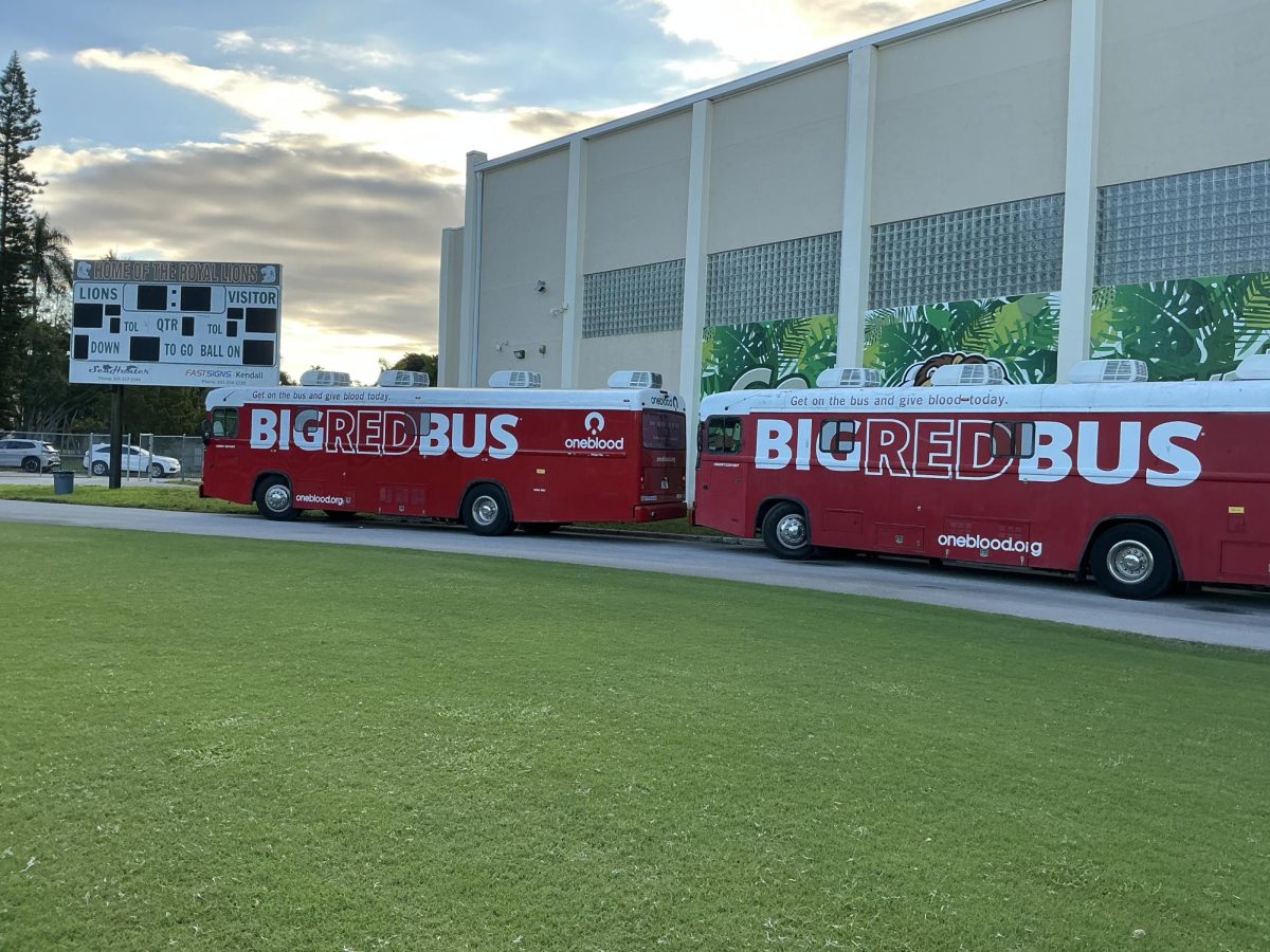 The big red busses are lined up on the track in front of the gym awaiting donations from Royal Lions.