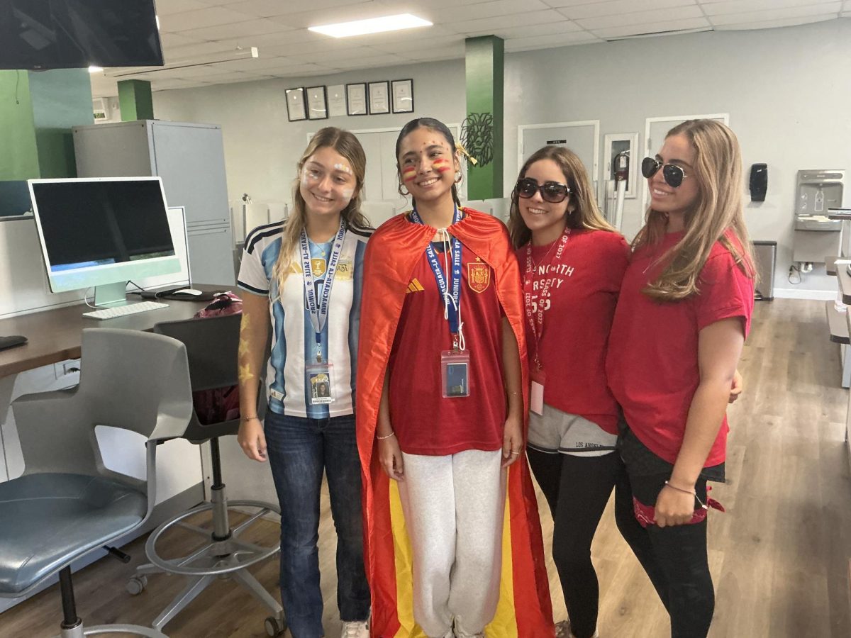 Senior and junior classmates gather in the classroom wearing international soccer jerseys and vibrant face paint to show off their heritage and sports passion. The theme day highlighted the diverse culture and active school spirit at Immaculata-La Salle High School.