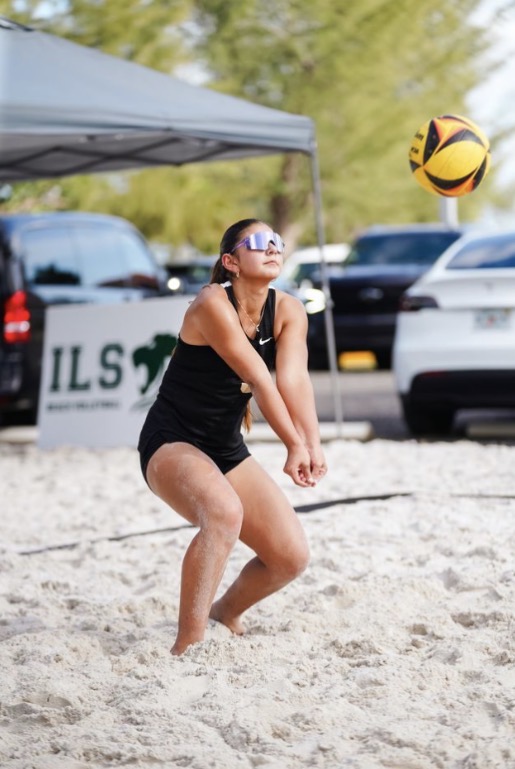 ILS Senior Sofia Rosales moves into action as she is about to receive a serve while practicing beach volleyball.