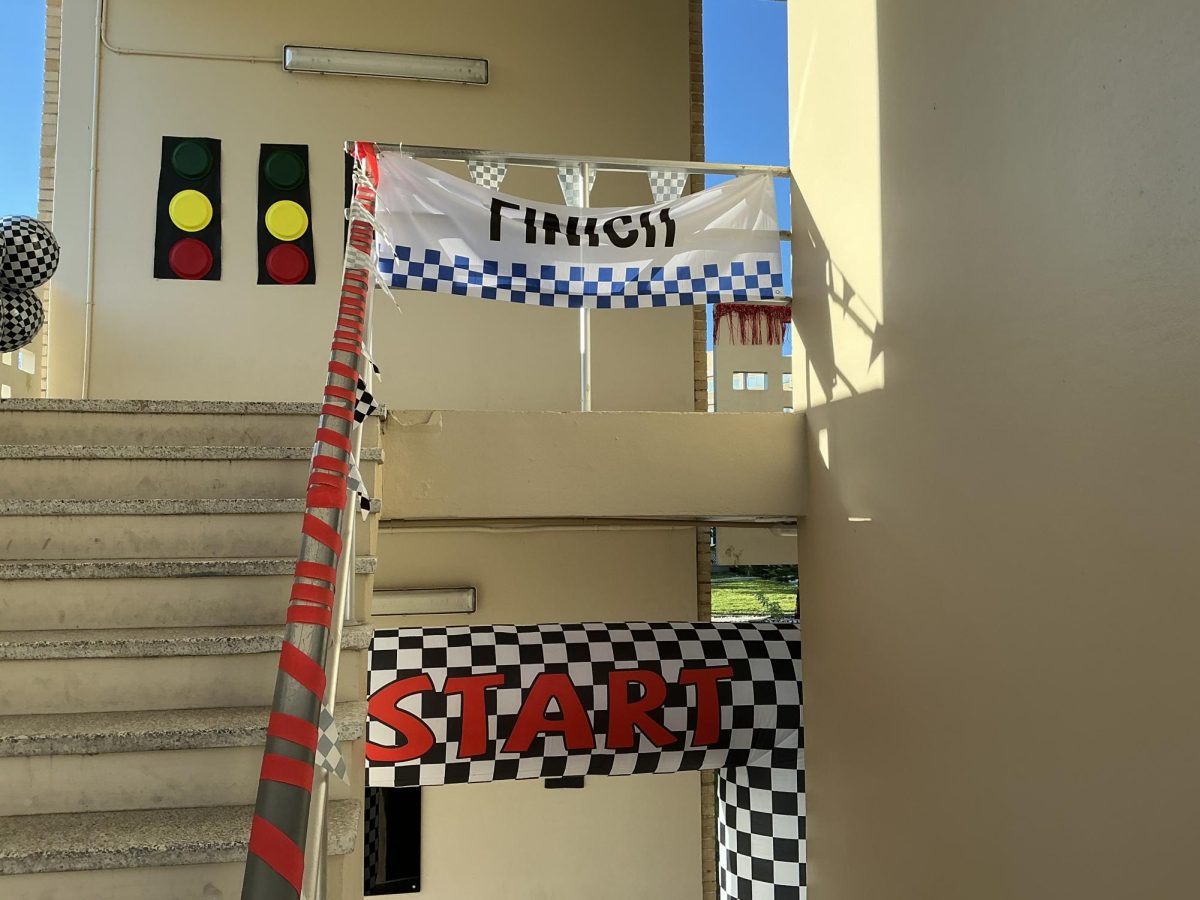 The decorated staircase of the 400 building features a start and finish line for the senior F1 theme.