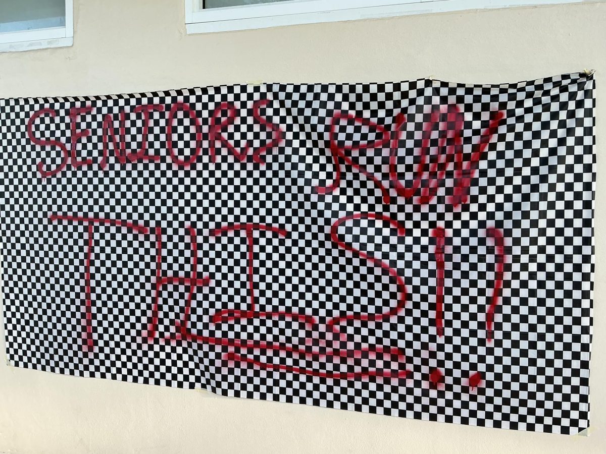 A F1-themed banner displays a senior message with checkered flags and red paint.