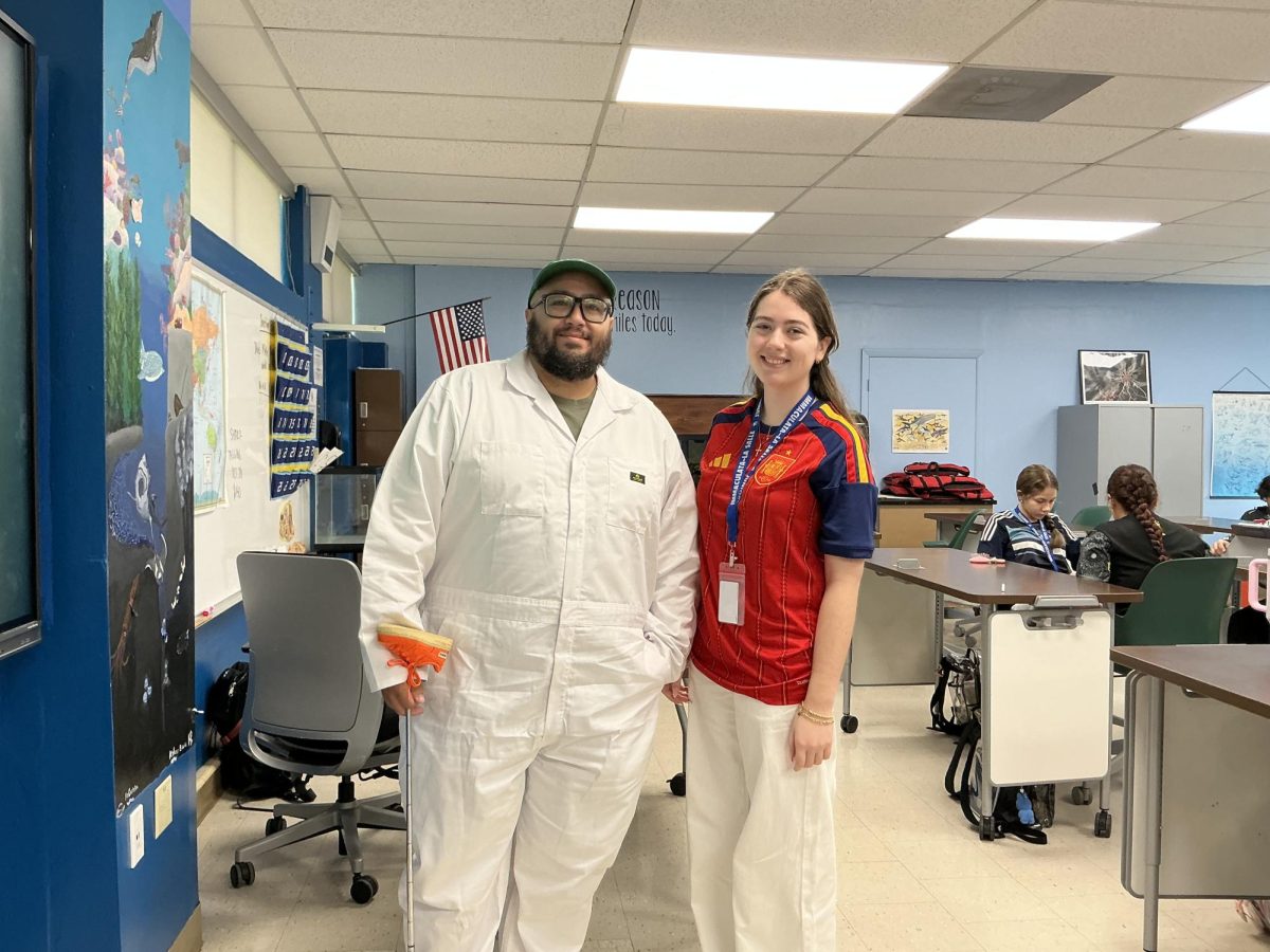 Mr. Jose Companioni poses next to junior Ariana Fallow embracing the “The Masters” and “FIFA World Cup” themes. 