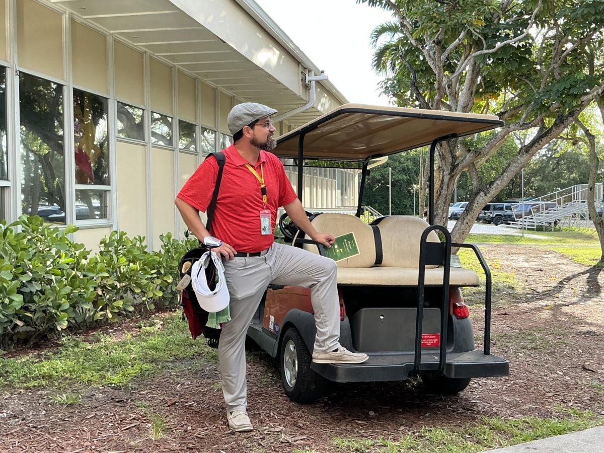 Dean of Students, Mr. Tim Gamwell, poses in his golf cart while waiting for his tee time at the ILS Marian Courtyard. 