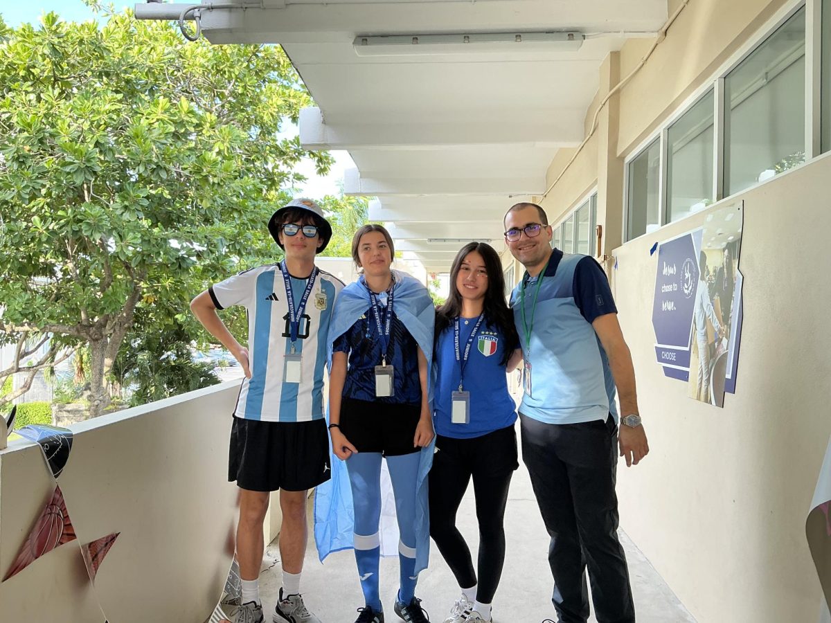 Juniors Benjamin Pieri, Elina Quirno-Costa, Sofia Gallo, and History teacher Mr. Galguera embrace their Homecoming-themed outfit. 