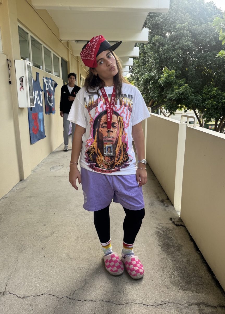 Senior Sienna Ferach wears pink slippers and purple shorts for Tacky Tuesday.