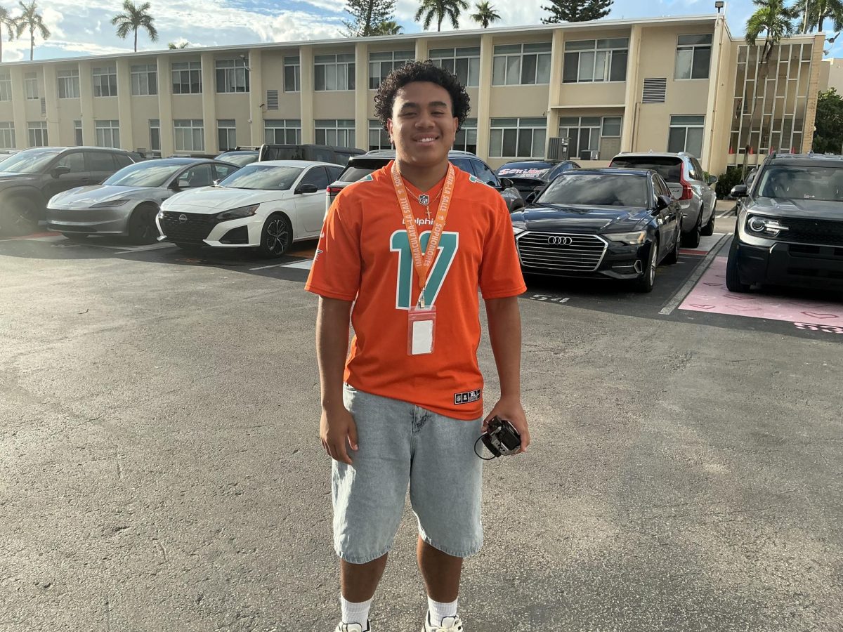 This sophomore is happy and repping his team the Miami dolphins for hoco week.