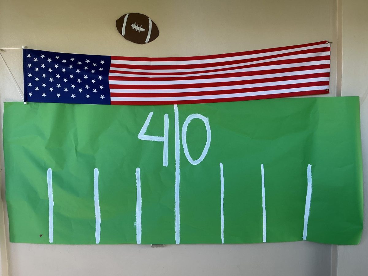 A handmade football field created by sophomores decorates the 800 building for the homecoming football theme. 