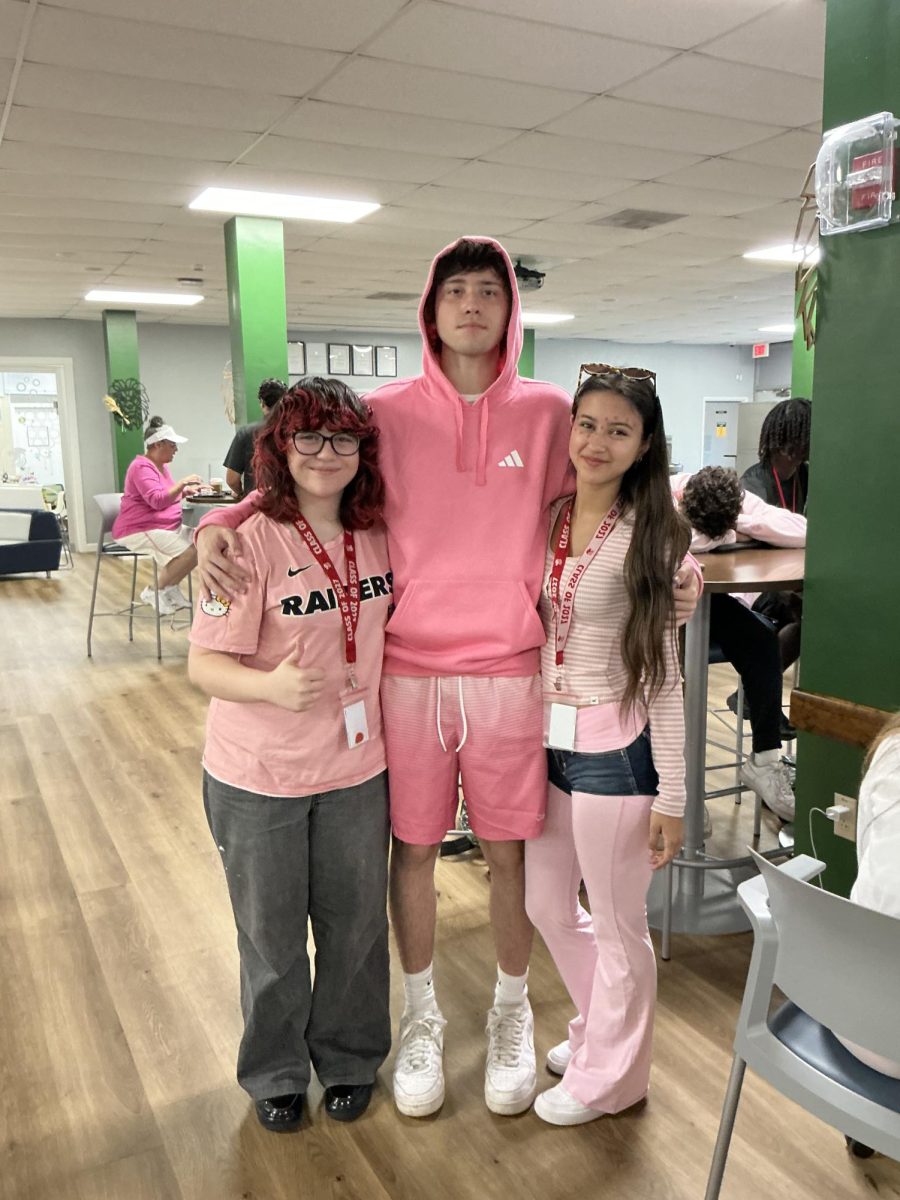 Seniors Isabella Iamunno, Gianluca Rua, and Valentina Rodriguez show off their pink outfits in support of Breast Cancer awareness.