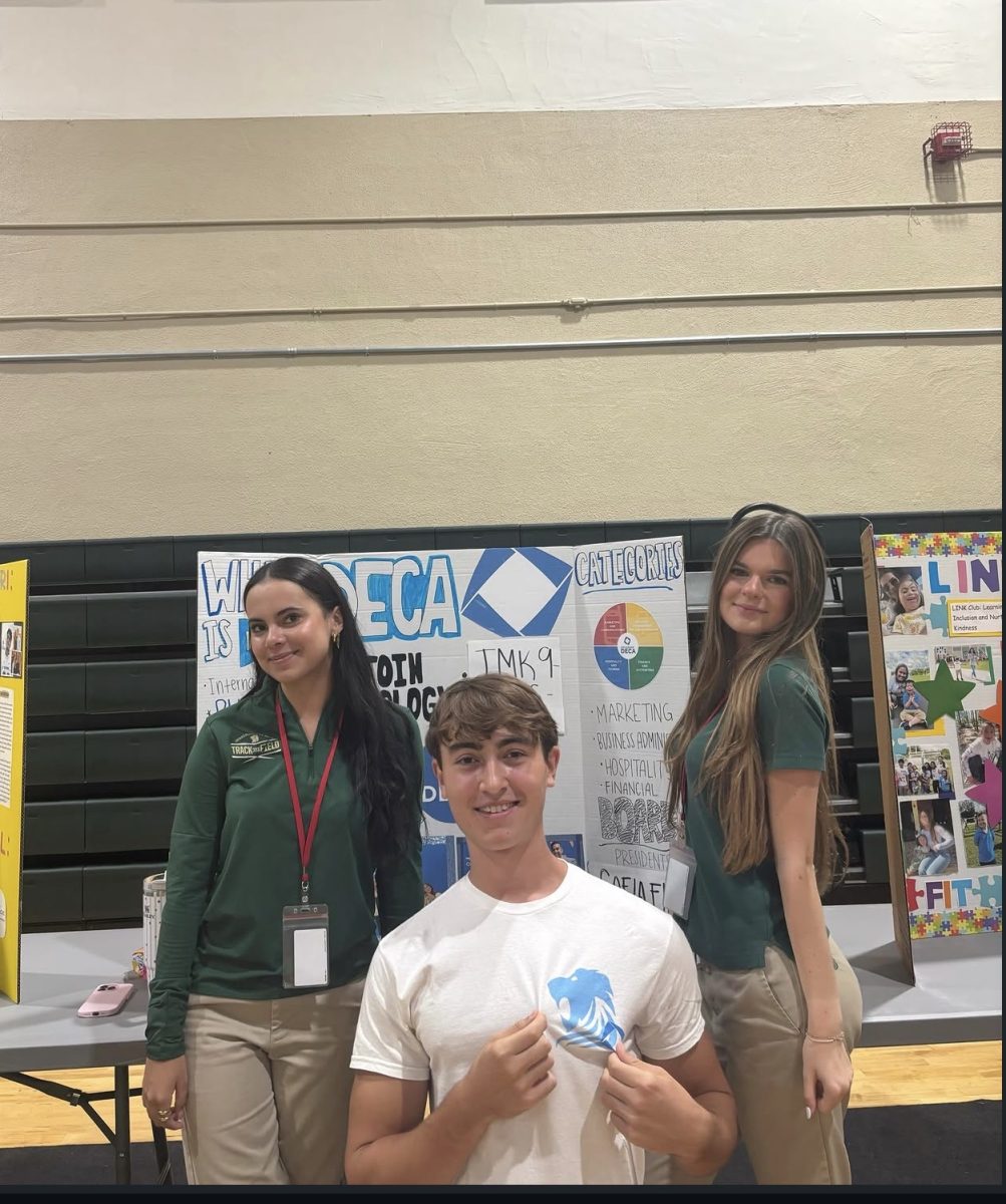 President Sofia Fink and members Luca Huidobro and Alessandra Malagon get ready for the Club Fair.