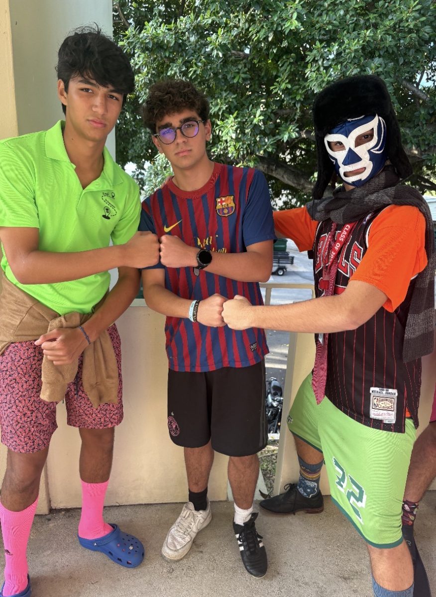 Three students pose together in their mismatched outfits, showing their school spirit and creativity.