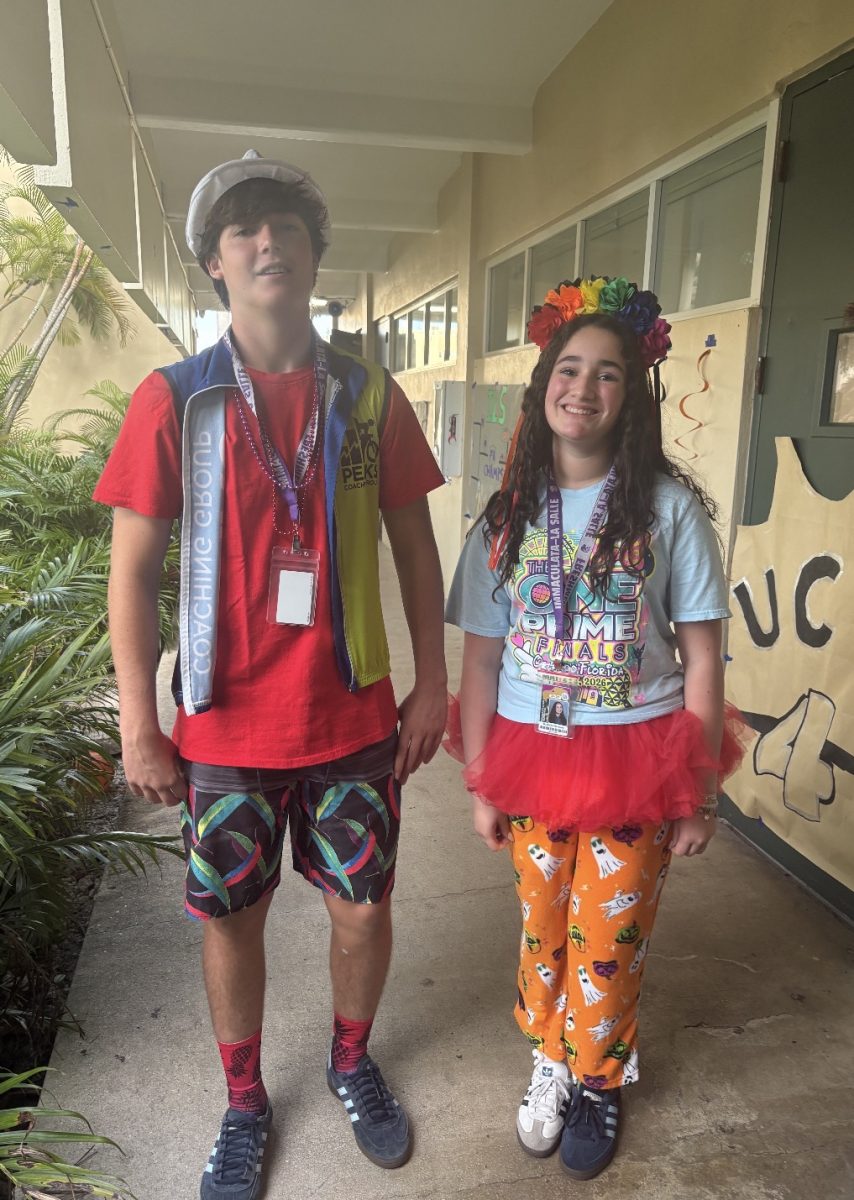 Two students show off their colorful and creative outfits while taking part in a fun school spirit day.