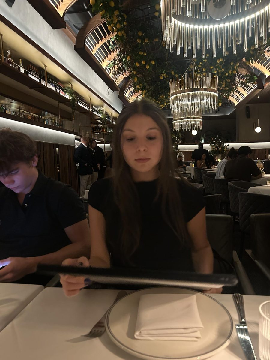 At Sparrow Wynwood, Mystra sits elegantly while waiting to order her meal.