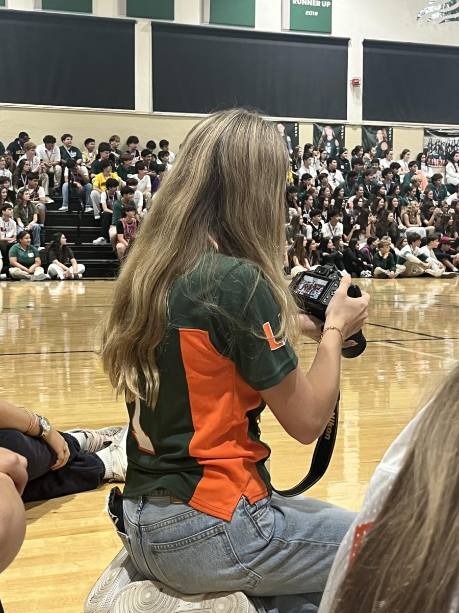 Sophomore Daisy Benz prepares to photograph the junior skit.