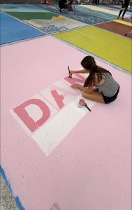 Senior Danielle Ramirez paints her parking spot selecting different shades of pink.